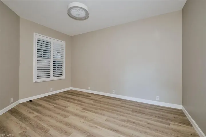 Spare room featuring light wood finished floors and baseboards
