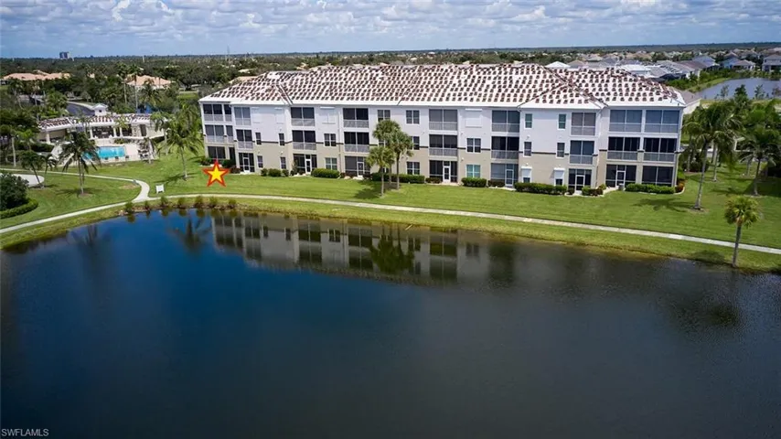 Drone / aerial view of apartment complex / building and a large body of water