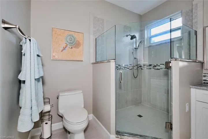 Bathroom featuring a shower stall and vanity
