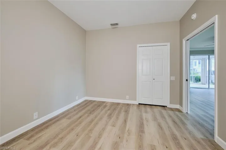 Unfurnished bedroom with light wood finished floors and a closet