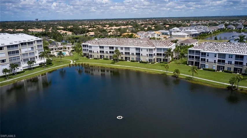 Aerial view of apartment complex / building and a large body of water