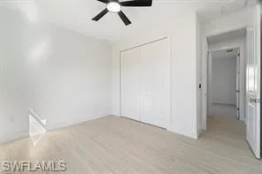Unfurnished bedroom with light wood finished floors, a closet, and ceiling fan