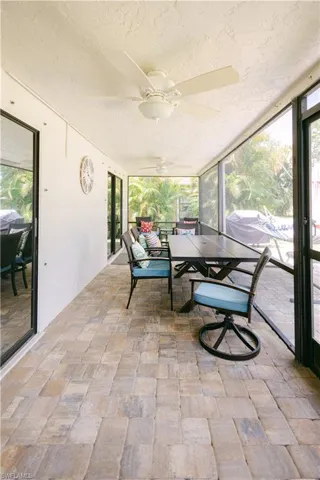 Sunroom featuring ceiling fan