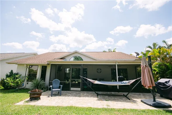 Rear view of house with a patio area and a fire pit