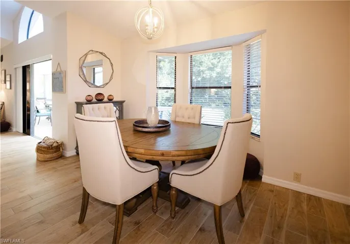 Dining area featuring a notable chandelier and hardwood / wood-style flooring