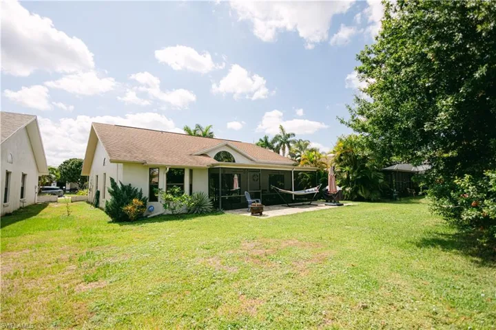 Back of property with a patio and a lawn