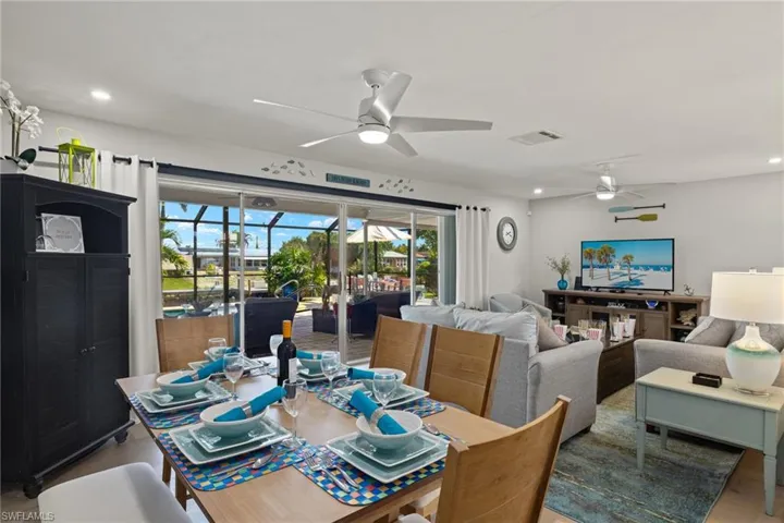 Dining space with ceiling fan and hardwood / wood-style flooring