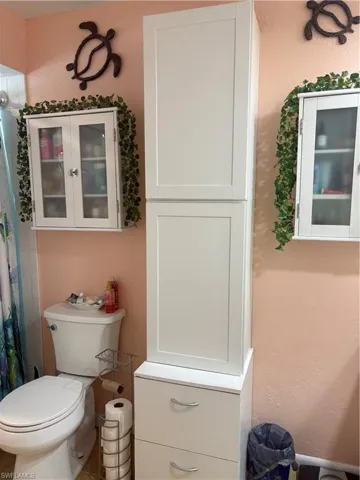 Bathroom featuring a textured wall and curtained shower