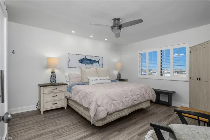 Bedroom featuring ceiling fan, wood finished floors, and recessed lighting