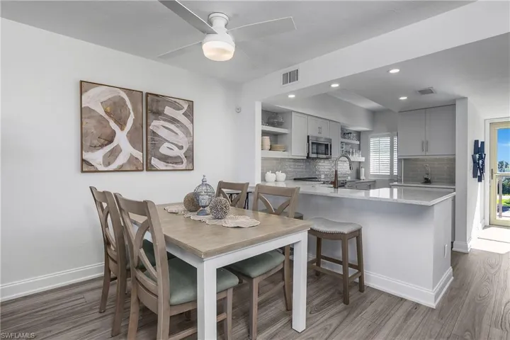 Dining area with light wood-style floors, recessed lighting, and ceiling fan
