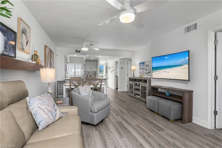 Living area featuring a ceiling fan and wood finished floors
