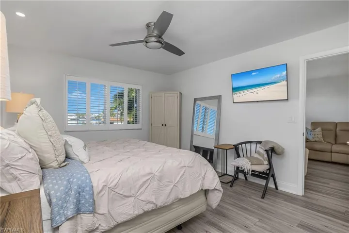 Bedroom with ceiling fan and wood finished floors