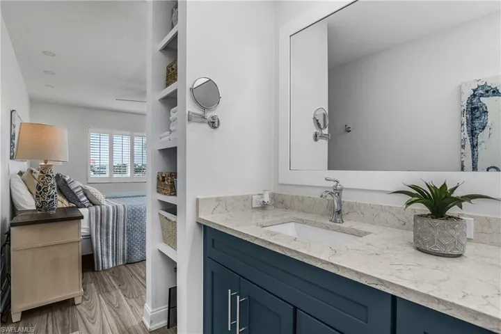 Bathroom featuring vanity, wood finished floors, and ensuite bath