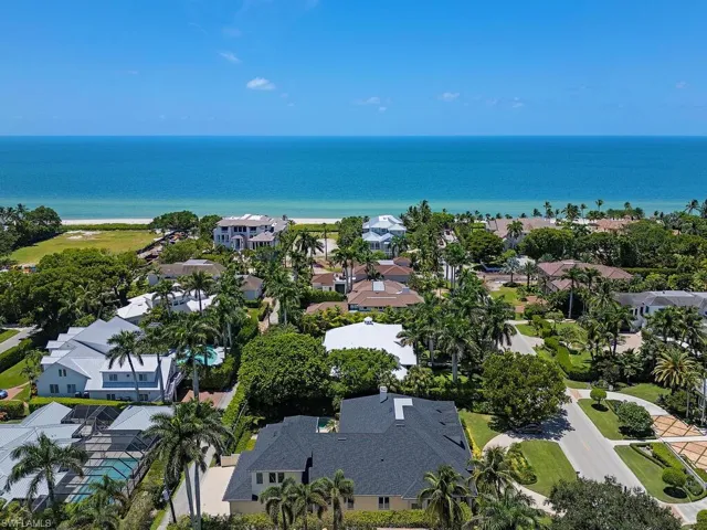 Aerial perspective of suburban area featuring a nearby body of water