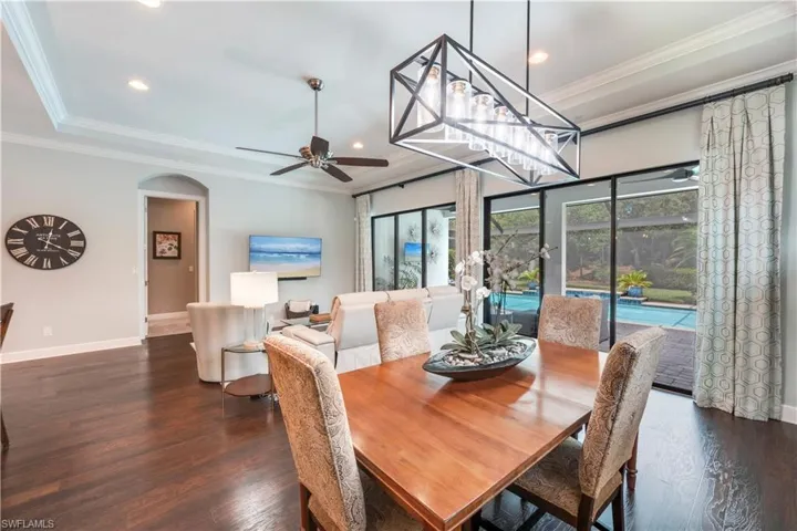 Dining space with ceiling fan, baseboards, wood finished floors, recessed lighting, and arched walkways