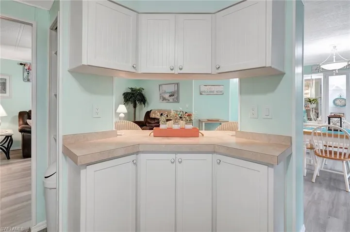 Kitchen with white cabinets and light hardwood / wood-style flooring