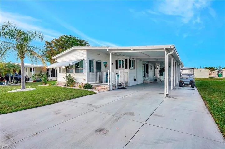 View of front of house featuring a front yard and a carport