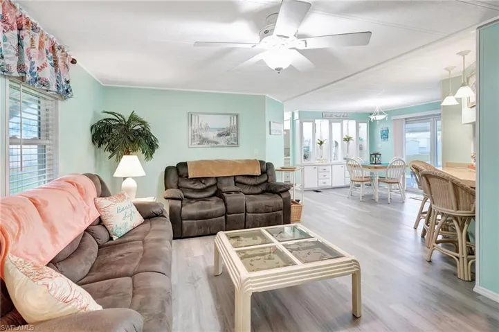 Living room with hardwood / wood-style floors and ceiling fan
