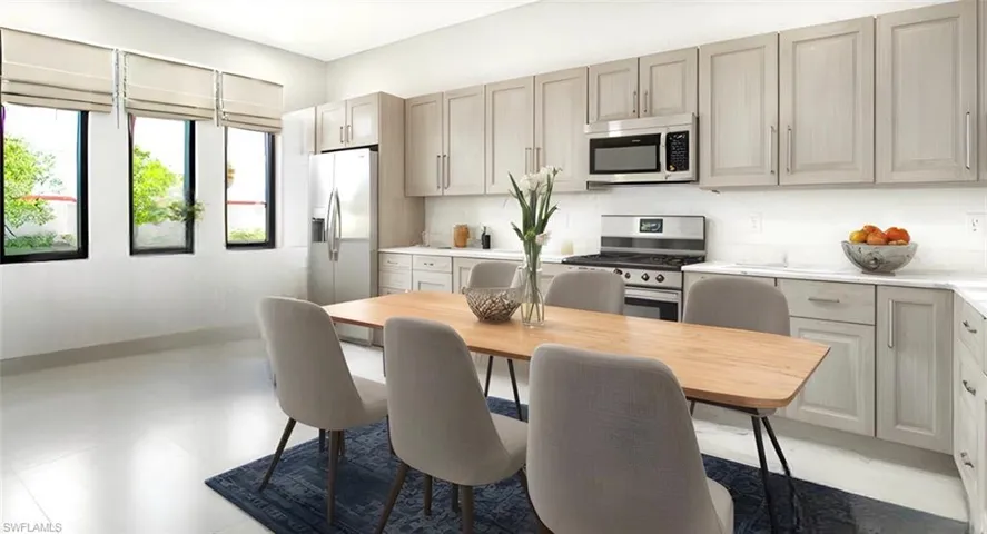 Kitchen with appliances with stainless steel finishes and backsplash