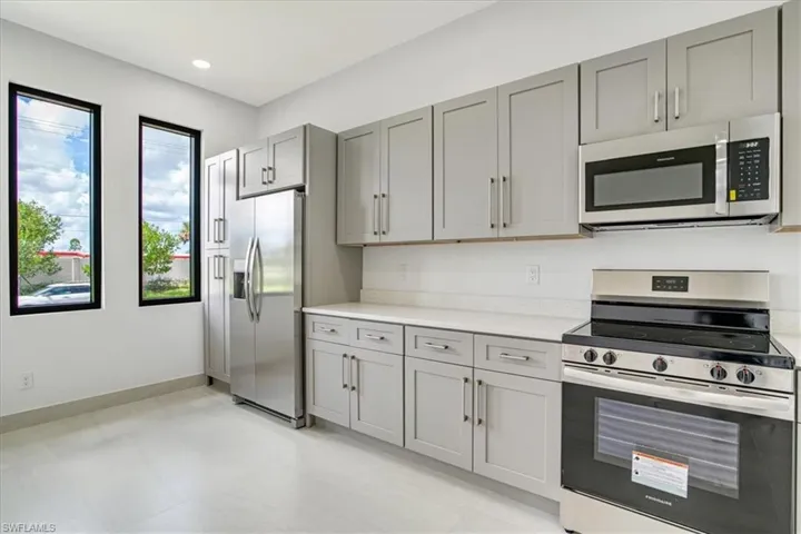 Kitchen featuring gray cabinets and stainless steel appliances