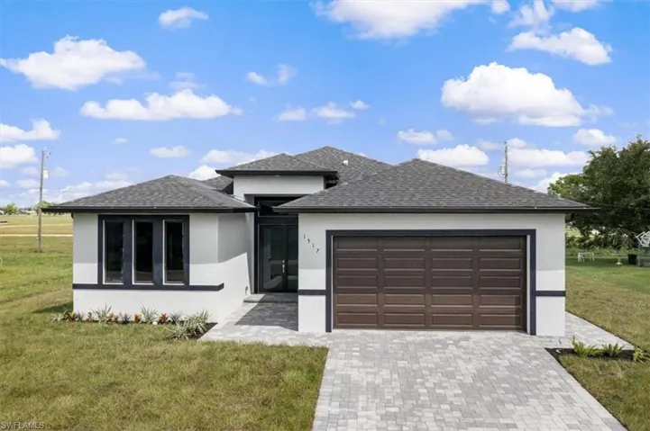 Prairie-style house featuring a garage and a front yard