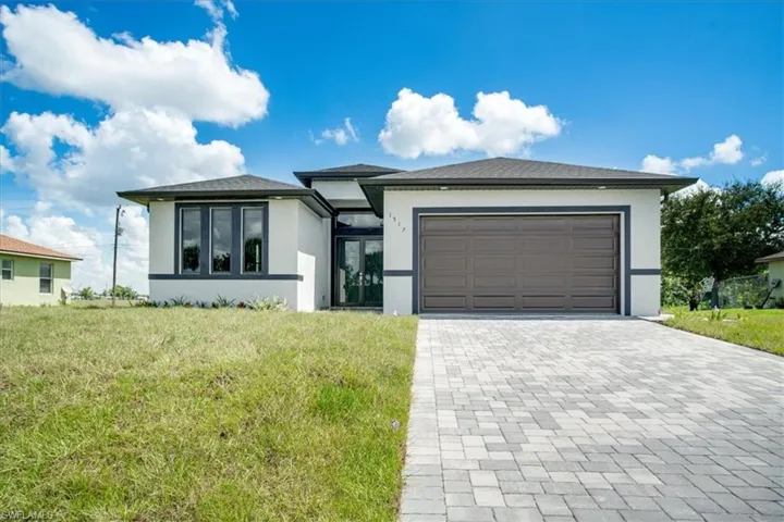 View of front facade with a front yard and a garage