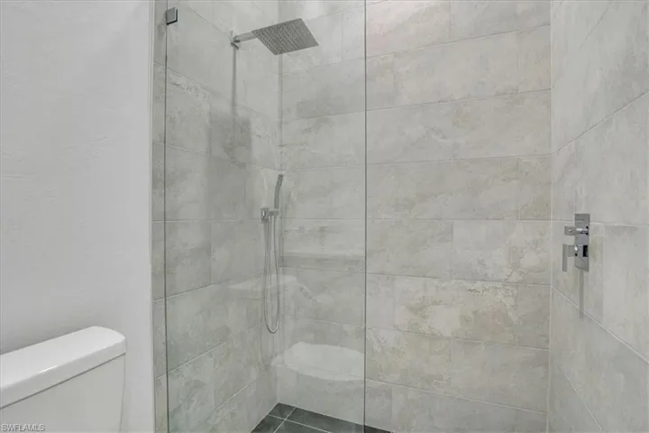 Guess Bathroom with toilet and a tile shower