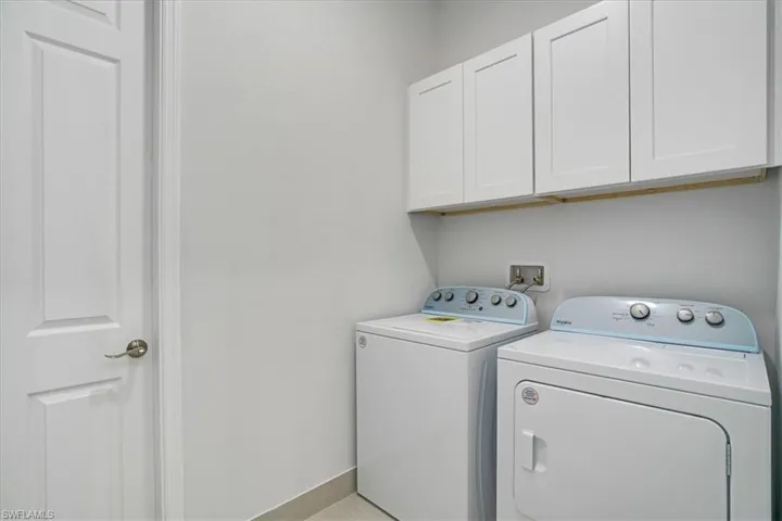 Laundry room with cabinets and washing machine and dryer