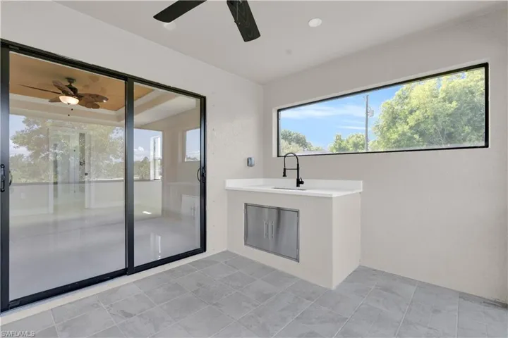View of patio / terrace with a ceiling fan and an outdoor kitchen