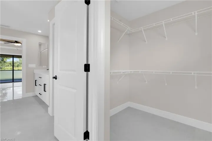 Spacious closet featuring a ceiling fan