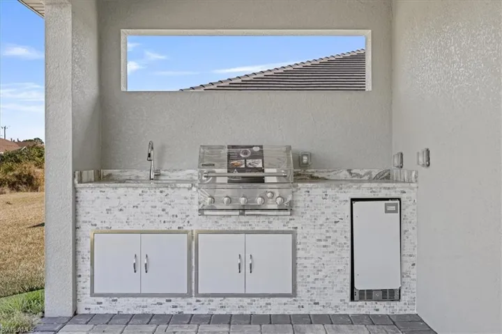View of patio / terrace featuring area for grilling and a sink