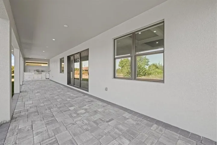 View of patio featuring an outdoor kitchen and a sink