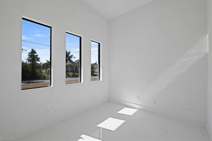 Unfurnished room featuring marble look tile flooring