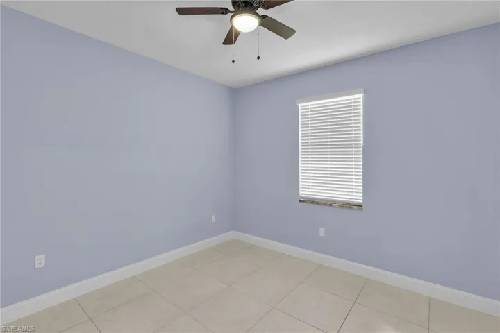 Tiled spare room with ceiling fan