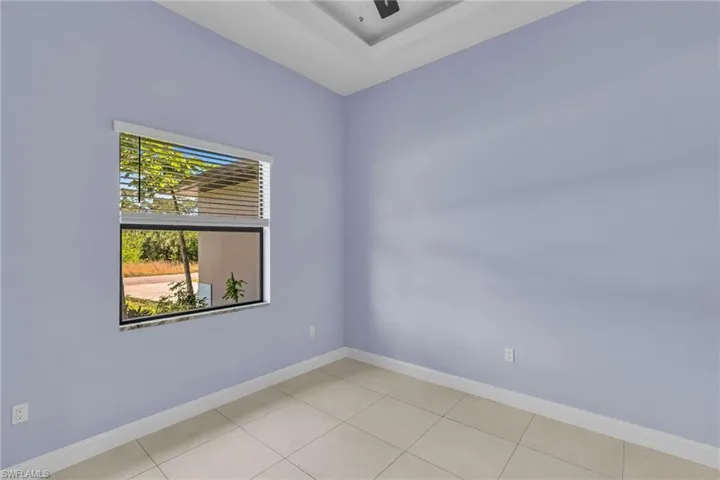 Spare room featuring ceiling fan and light tile patterned flooring