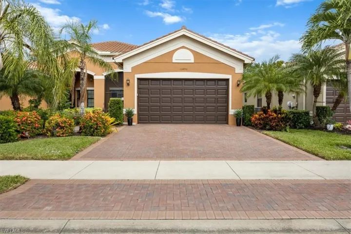 Mediterranean / spanish-style home with stucco siding, decorative driveway, a garage, and a tiled roof