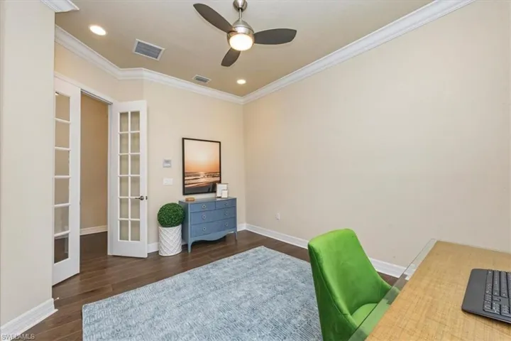 Home office featuring french doors, dark wood-style flooring, recessed lighting, ornamental molding, and a ceiling fan