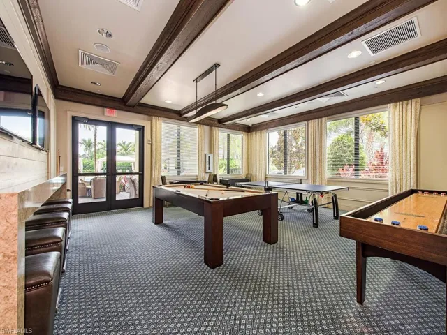 Playroom featuring beam ceiling, french doors, billiards table, healthy amount of natural light, and crown molding