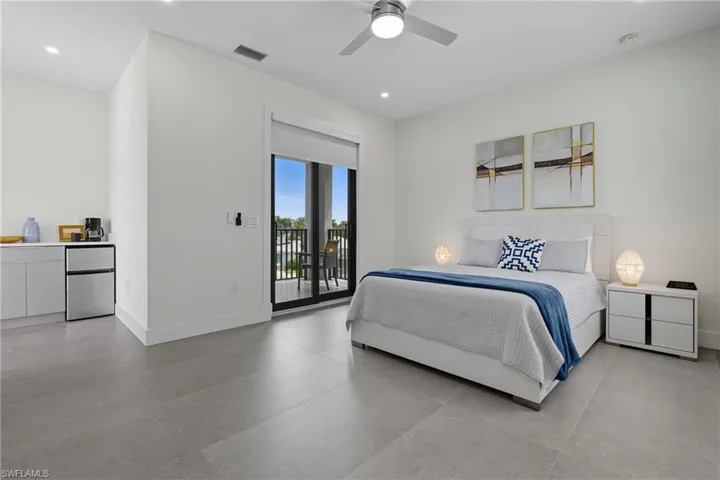 Bedroom featuring freestanding refrigerator, recessed lighting, access to outside, and a ceiling fan