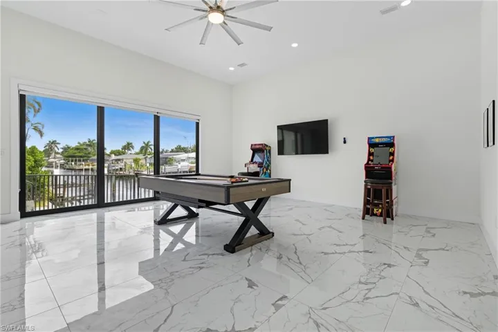 Game room featuring light marble finish floors, recessed lighting, ceiling fan, and pool table