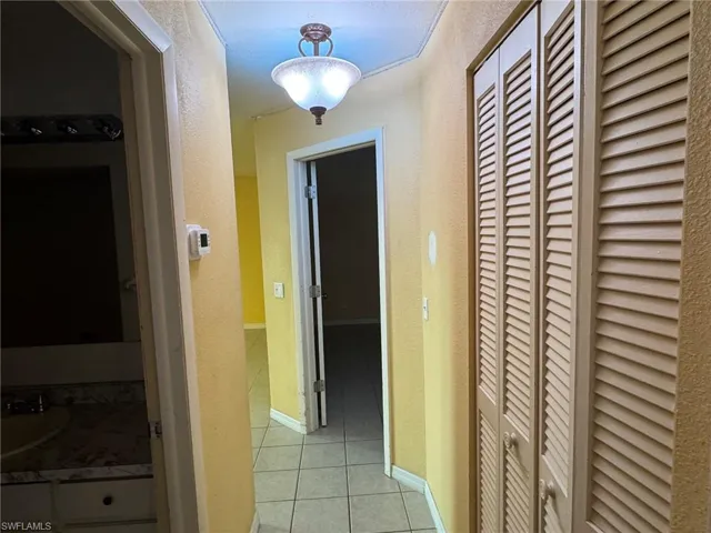 Hallway featuring ceramic tile flooring and a ceiling-mounted light fixture.