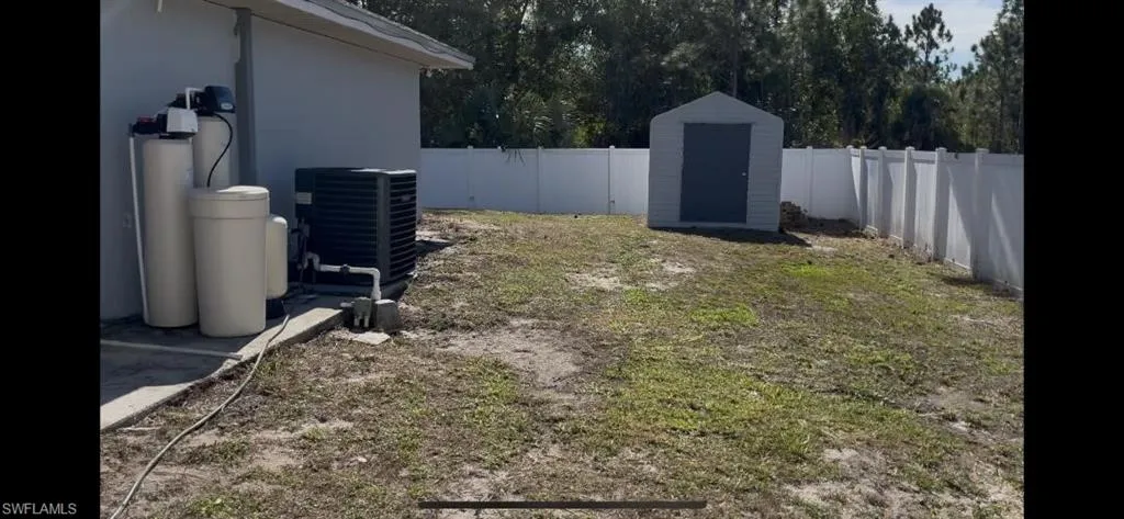 Fenced backyard with a storage unit