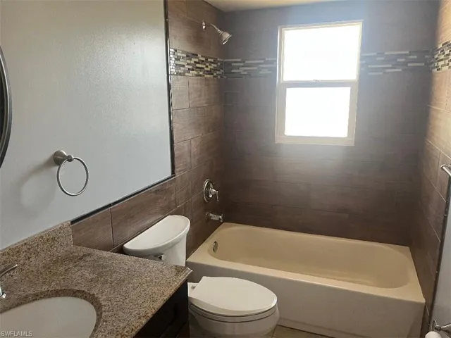 Bathroom featuring shower / tub combination and vanity