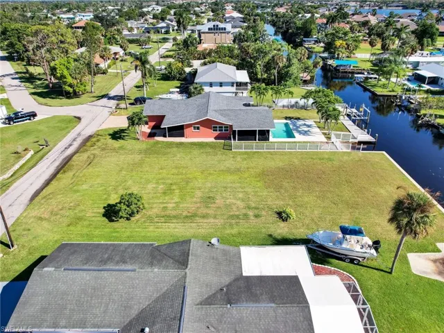 Birds eye view of property with a water view