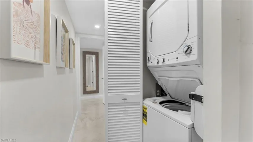 Laundry area featuring stacked washer / drying machine