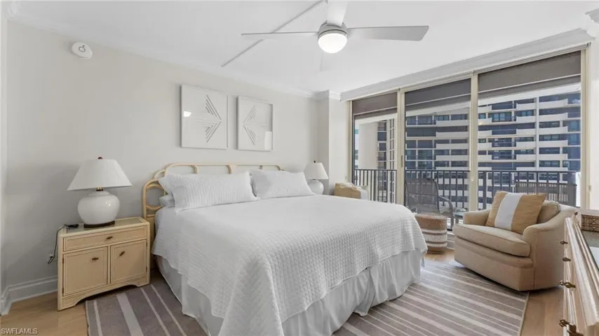 Bedroom with a wall of windows, light hardwood / wood-style floors, access to exterior, crown molding, and ceiling fan