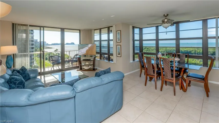 Tiled living room featuring baseboards and ceiling fan