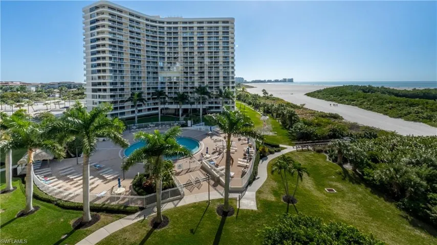 Drone / aerial view of a large body of water and apartment complex / building