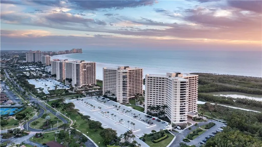Aerial view at dusk of a water view, a view of city, and a view of apartment building / complex