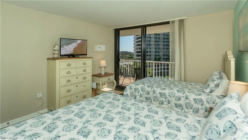 Bedroom featuring access to outside and floor to ceiling windows